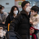 Passengers wear protective masks in the arrivals area at Beijing Capital Airport on January 30, 2020.
